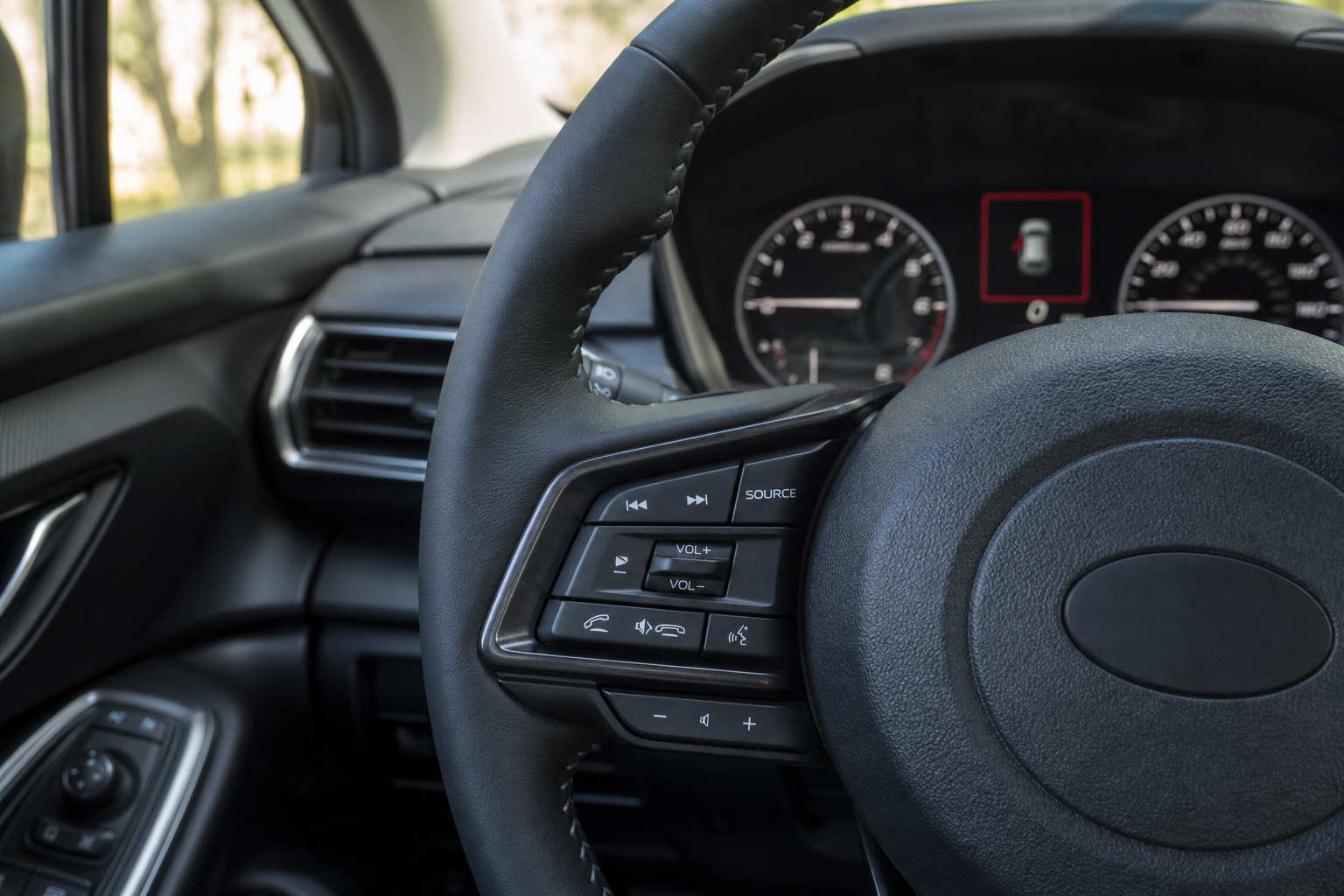 Close-up of steering wheel controls inside a Subaru Crosstrek