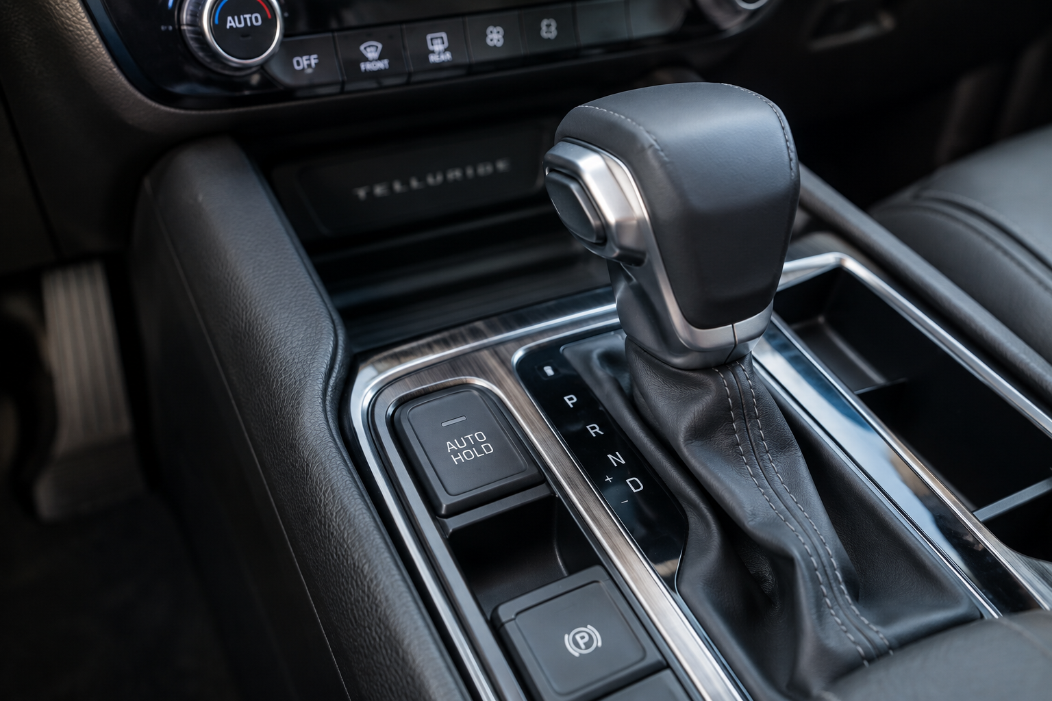 Close-up of Kia Telluride Auto Hold button on center console in inactive state